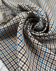 Mixed polyester comfort stretch, with checked design in the shades of beige, color reference natural, and turquoise, color reference fiod blue. A little heavy and flowy, ideal for trousers and jackets. High-quality deadstock collected in Stock from a Maison de Couture in Italy.