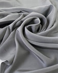 Pure silk crepe de chine in goth gray. Very soft and light, flowy, and not transparent. Ideal for shirting, blouses, dresses, and skirts. High-quality deadstock collected in Stock from a Maison de Couture in Italy.