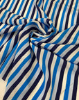 Pure silk crêpe de chine with stripe design in the shades of white, dark blue, light blue and turquoise. Very soft and light, flowy and not transparent. Ideal for dresses, skirts, blouses, and shirting. High-quality deadstock collected in Stock from a Maison de Couture in Italy.