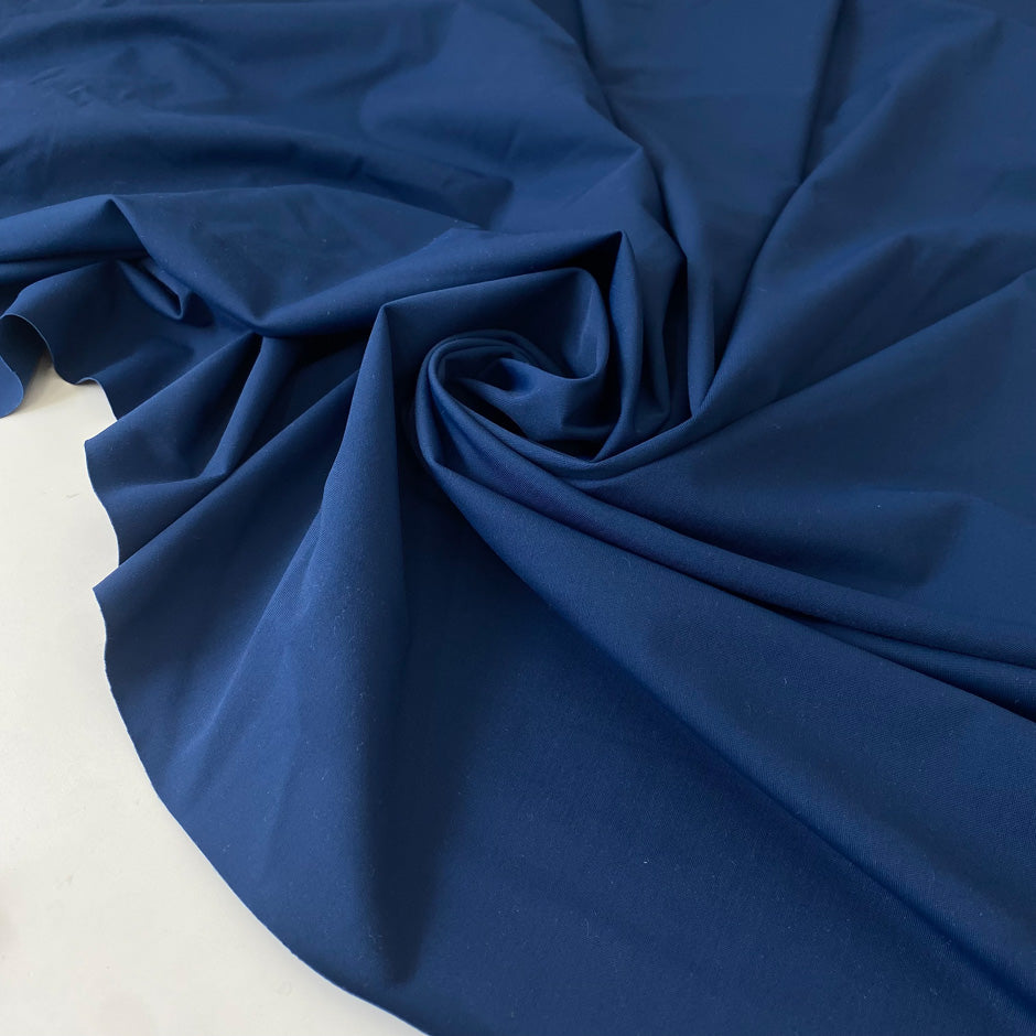 Stretch Lycra fabric in dark blue, very soft and flowy with a smooth hand and no transparency. Perfect for dresses, trousers, skirts, swimwear, and shapewear. High-quality deadstock collected in Stock from a Maison de Couture in Italy.