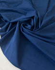 Stretch Lycra fabric in dark blue, very soft and flowy with a smooth hand and no transparency. Perfect for dresses, trousers, skirts, swimwear, and shapewear. High-quality deadstock collected in Stock from a Maison de Couture in Italy.