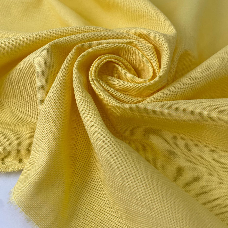 Pure cotton in sun struck yellow, slightly heavy with a rough, linen-like texture. Perfect for dresses, jackets, or skirts. High-quality deadstock collected in Stock from a Maison de Couture in Italy.