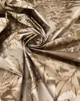 Stiff viscose and polyester taffeta printed with a jungle leaf design in sand and beige shades. Adds volume and holds shape, ideal for skirts, trench coats, and dresses. High-quality deadstock collected in Stock from a Maison de Couture in Italy.