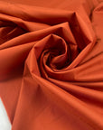 Light stretch nylon in spice route color, very light and flowy. Ideal for raincoats and jackets. High-quality deadstock collected in Stock from a Maison de Couture in Italy.