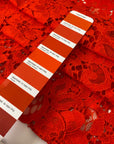 Cotton and polyester lace in tomato red with a delicate flower design, soft and light. Ideal for dresses, blouses, and skirts. High-quality deadstock collected in Stock from a Maison de Couture in Italy.