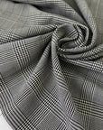 Soft stretch wool with a classic Prince of Wales design in black and white. Perfect for trousers, dresses, skirts, and jackets.High-quality deadstock collected in Stock from a Maison de Couture in Italy.