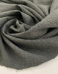 Light gray polyester seersucker with a crisp, puckered texture. Perfect for airy, wrinkle-resistant garments. High-quality deadstock collected in Stock from a Maison de Couture in Italy.