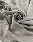 Stretch fabric with textured surface in light gray color reference Quiet Gray. Very soft and light, ideal for t-shirts and dresses. High-quality deadstock collected in Stock from a Maison de Couture in Italy.