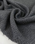 Wool and polyester tweed in smoked pearl grey. Very soft, flowy and medium weight. Ideal for light coats and jackets. High-quality deadstock collected in Stock from a Maison de Couture in Italy.