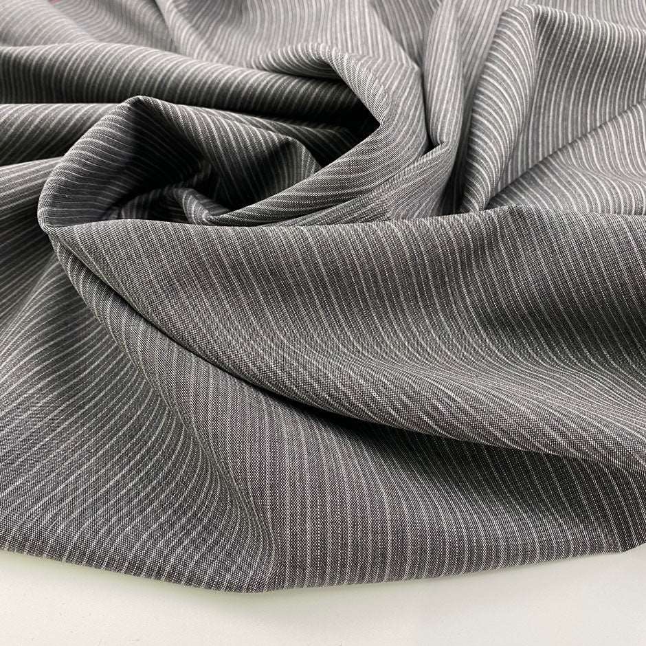 Gray and white stretch wool pinstripes. High quality deadstock fabric.