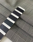 Soft stretch wool with a classic Prince of Wales design in black and white. Perfect for trousers, dresses, skirts, and jackets.High-quality deadstock collected in Stock from a Maison de Couture in Italy.