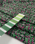 Viscose and wool crepe with a beautiful small flower design, the ground is green and the flowers are in white, fuchsia, and black shades. It is very soft and light. High-quality deadstock fabric by the meter collected in Stock from a Maison de Couture in Italy.