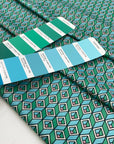 Very soft, smooth, and light polyester satin with a small geometric design in shades of light blue, green, and pink. Not transparent. High-quality deadstock collected in Stock from a Maison de Couture in Italy.