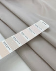Double-face mikado in polyester and silk with pale rose tones, structured and elegant, ideal for dresses, skirts, and formal jackets. High-quality deadstock collected in Stock from a Maison de Couture in Italy.