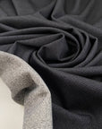 Double-face polyester and elastane fabric with dark grey front and light grey back, very soft and medium weight, ideal for reversible garments, jackets, and dresses. High-quality deadstock collected in Stock from a Maison de Couture in Italy.