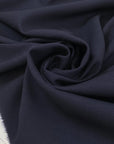 Wool and cotton blend in dark blue with a textured surface. Very soft and light, not transparent. Ideal for dresses, skirts, jackets, and light trousers. High-quality deadstock collected in Stock from a Maison de Couture in Italy.
