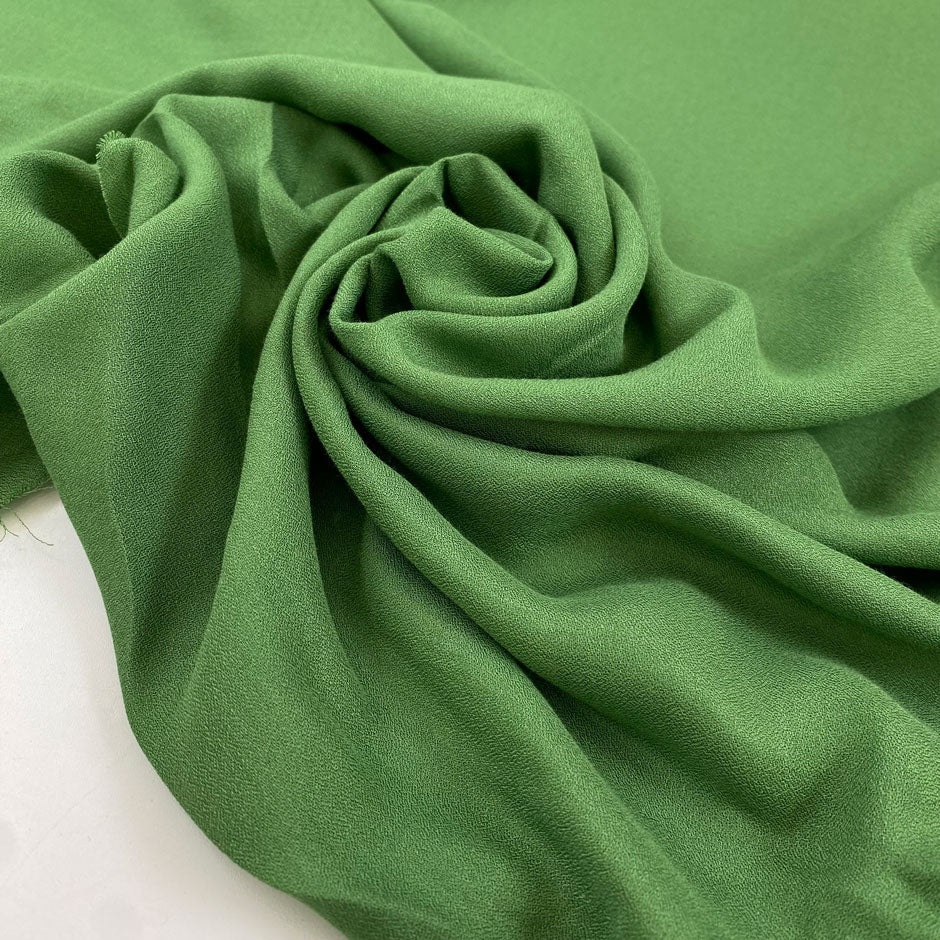 Pure viscose very soft and flowy, in green. Ideal for blouses, shirts, skirts, and dresses. High-quality deadstock fabric by the meter collected in Stock from a Maison de Couture in Italy.