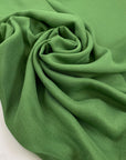 Pure viscose very soft and flowy, in green. Ideal for blouses, shirts, skirts, and dresses. High-quality deadstock fabric by the meter collected in Stock from a Maison de Couture in Italy.