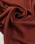 Pure viscose, very soft, light, and flowy in cinnabar dark red. Ideal for skirts, blouses, shirts, and dresses. High-quality deadstock fabric by the meter collected in Stock from a Maison de Couture in Italy.