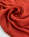 Pure viscose, very soft and light, flowy in Fire Whirl red. Ideal for shirts, blouses, skirts, and dresses. High-quality deadstock fabric by the meter collected in Stock from a Maison de Couture in Italy.