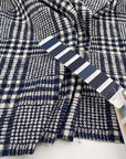 Stretch cotton-polyester blend with jacquard Prince of Wales pattern and blue and white double face. High quality deadstock fabric.