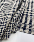 Stretch cotton-polyester blend with jacquard Prince of Wales pattern and blue and white double face. High quality deadstock fabric.