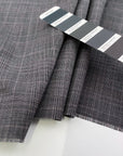 Textured wool cloth with Prince of Wales pattern in gray and purple. High quality deadstock fabric.