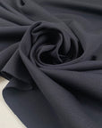 Soft knit polyester jersey piquet in anthracite piquet texture ideal for sporty garments and modern basics. High-quality deadstock collected in Stock from a Maison de Couture in Italy.