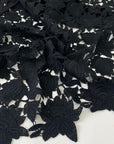 Black lace in wool and polyester with double scallop detail. Soft and elegant, ideal for dresses, skirts, and blouses. High-quality deadstock collected in Stock from a Maison de Couture in Italy.