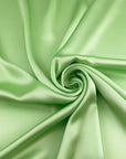 Light green polyester sateen with a soft, fluid drape and a non-stretch construction. Ideal for creating trousers and dresses. High-quality deadstock collected in Stock from a Maison de Couture in Italy.