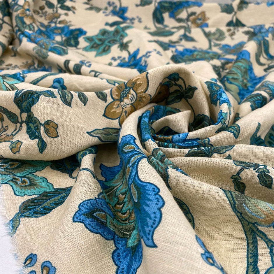 Cotton and linen, the ground is sand color, with beautiful flower designs in shades of light blue and green. It is very soft and light. High-quality deadstock fabric collected in Stock from a Maison de Couture in Italy.