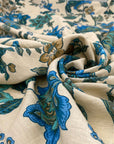 Cotton and linen, the ground is sand color, with beautiful flower designs in shades of light blue and green. It is very soft and light. High-quality deadstock fabric collected in Stock from a Maison de Couture in Italy.