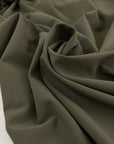 Stretch cotton cady in mud color, very soft and flowy, ideal for dresses, trousers, and elegant separates. High-quality deadstock collected in Stock from a Maison de Couture in Italy.