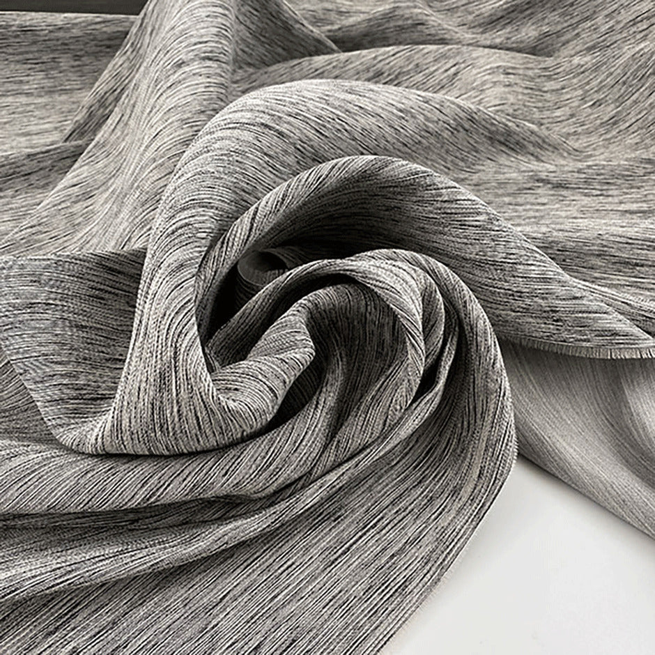 Jacquard of wool, silk, polyester and textile paper yarn dyed in irregular textured weave