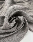 Jacquard of wool, silk, polyester and textile paper yarn dyed in irregular textured weave