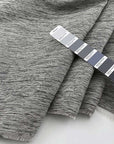 Jacquard of wool, silk, polyester and textile paper yarn dyed in irregular textured weave