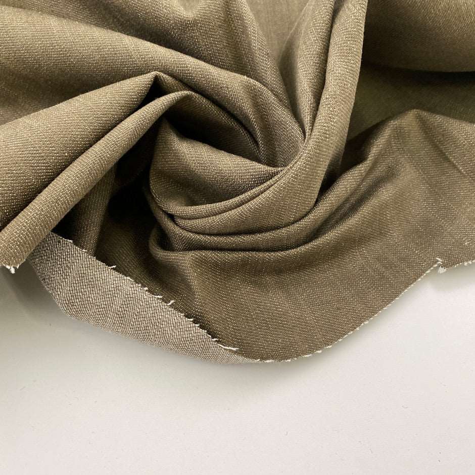 Solid beige stiff stretch yarn-dyed fabric. Deadstock fabric picked up in Stock from a Maison de Couture in Italy.