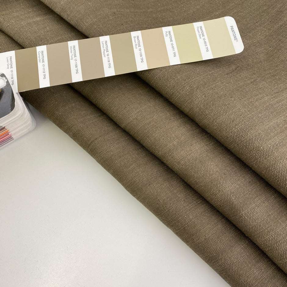 Solid beige stiff stretch yarn-dyed fabric. Deadstock fabric picked up in Stock from a Maison de Couture in Italy.