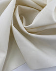 Deadstock cream wool gabardine with fliseline, ideal for eco-conscious elegant fashion.