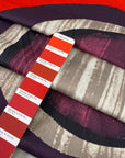 White pure cotton satin with elastane featuring a panel on the edge in rare red, violet, gray and fuchsia. Very soft, flowy and medium weight. Ideal for trousers, skirts and dresses. High-quality deadstock collected in Stock from a Maison de Couture in Italy.