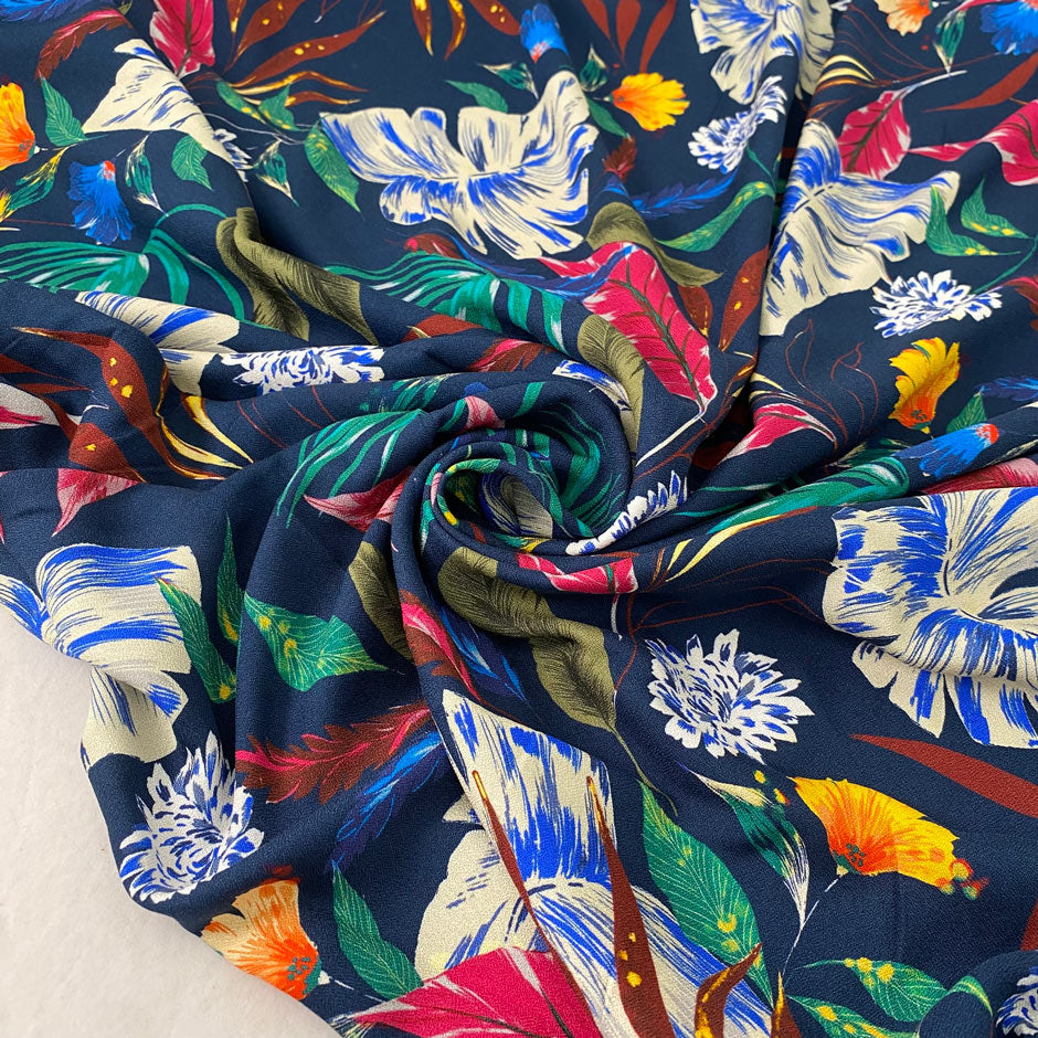 Pure viscose printed with a multicolor tropical design. The ground is dark blue, color reference oceana. Very soft and flowy, ideal for dresses, trousers, skirts, and blouses. High-quality deadstock collected in Stock from a Maison de Couture in Italy.