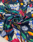 Pure viscose printed with a multicolor tropical design. The ground is dark blue, color reference oceana. Very soft and flowy, ideal for dresses, trousers, skirts, and blouses. High-quality deadstock collected in Stock from a Maison de Couture in Italy.