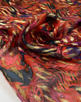 Silk chiffon printed with tropical leaf design in the shades of bright red, blue and violet. With gold lured brushstrokes. Light, soft and transparent. High-quality deadstock fabric collected in Stock from a Maison de Couture in Italy.