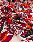 Printed viscose with tropical flower design in white, fuchsia, orange, and red shades. Very soft, light, and flowy. High-quality deadstock fabric by the meter collected in Stock from a Maison de Couture in Italy.
