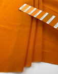 Soft and droopy silk crepe de chine in orange. High-quality fabric deadstock