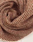 Orange and white cotton and viscose tweed. It feels droopy and stretchy. High quality deadstock fabric. 