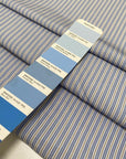 Soft and lightweight pure cotton poplin with stripes in light blue, white, and ochre. Not transparent, perfect for shirting and dresses.High-quality deadstock collected in Stock from a Maison de Couture in Italy.