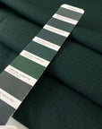 Soft and flowing wool and viscose stretch double crêpe in dark green. Perfect for jackets, skirts, and dresses.High-quality deadstock collected in Stock from a Maison de Couture in Italy.