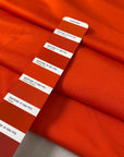 Orange cotton and viscose technical piquet jersey in cherry tomato shade soft stretchy and fluid. Ideal for sweatshirts, trousers, skirts and jackets. High-quality deadstock collected in Stock from a Maison de Couture in Italy.