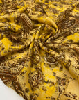 Very soft and light viscose muslin with a paisley design in mustard and brown. Flowy and not transparent, ideal for scarves, light shirting, and airy dresses. High-quality deadstock collected in Stock from a Maison de Couture in Italy.